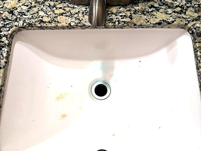 Clean bathroom sink and granite counter